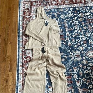 Cream full-length jumpsuit with long sleeves and collar
